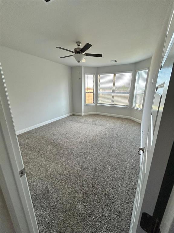 1704 Dunbrook Road McKinney, TX 75071 - Photo 16 of 17 Master Bedroom featuring carpet floors, Bay window and ceiling fan
