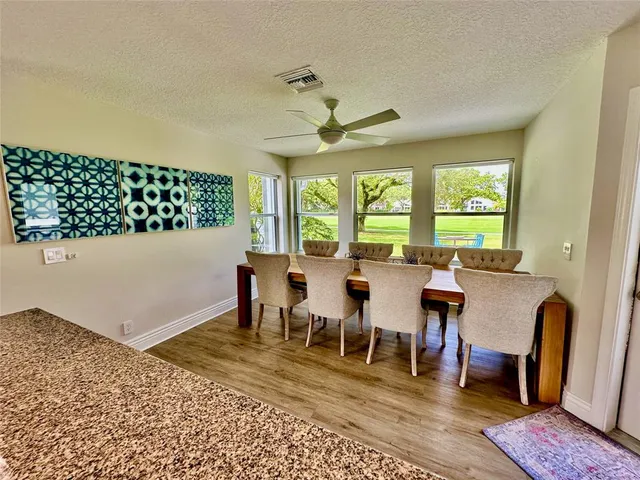 a kitchen with stainless steel appliances granite countertop a refrigerator a stove top oven a sink and dishwasher