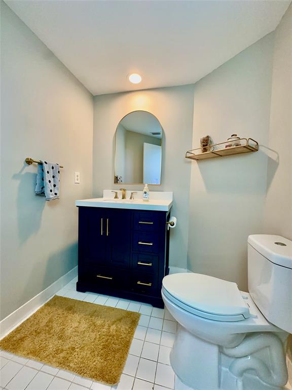 2295 Northwest 53rd Street Boca Raton, FL 33496 - Photo 16 of 89 a bathroom with a toilet a sink and mirror