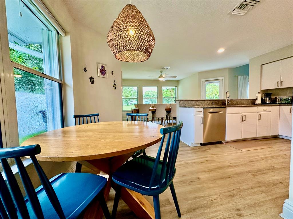 2295 Northwest 53rd Street Boca Raton, FL 33496 - Photo 19 of 89 a view of a dining room with furniture window and wooden floor