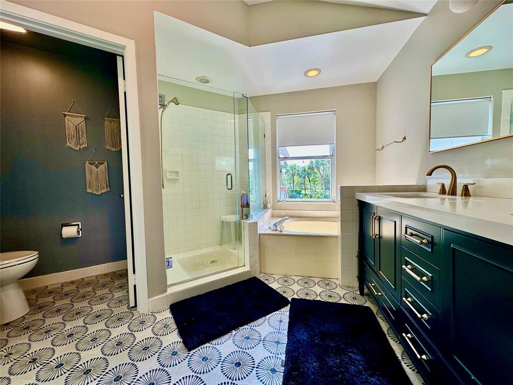 2295 Northwest 53rd Street Boca Raton, FL 33496 - Photo 29 of 89 a bathroom with a sink a toilet and shower