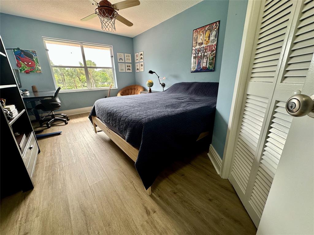 2295 Northwest 53rd Street Boca Raton, FL 33496 - Photo 31 of 89 a bedroom with a bed and a window