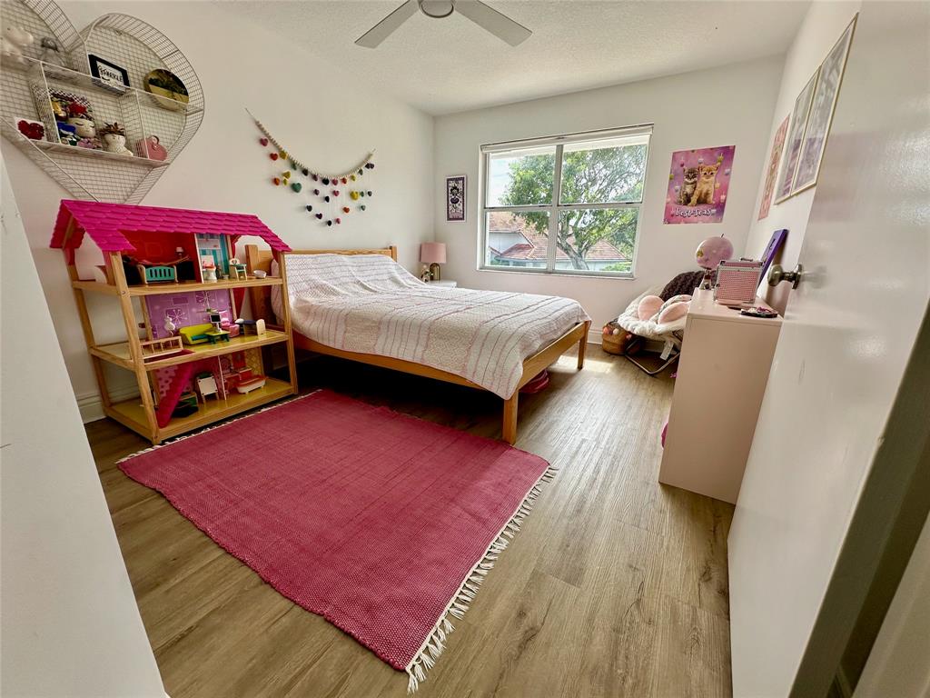 2295 Northwest 53rd Street Boca Raton, FL 33496 - Photo 32 of 89 a bedroom with a bed and a window