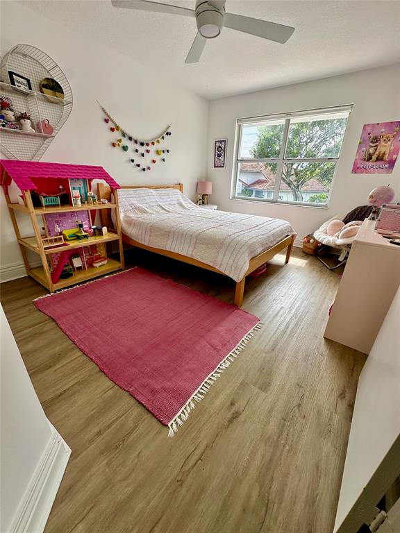 2295 Northwest 53rd Street Boca Raton, FL 33496 - Photo 33 of 89 a bedroom with a bed and a window