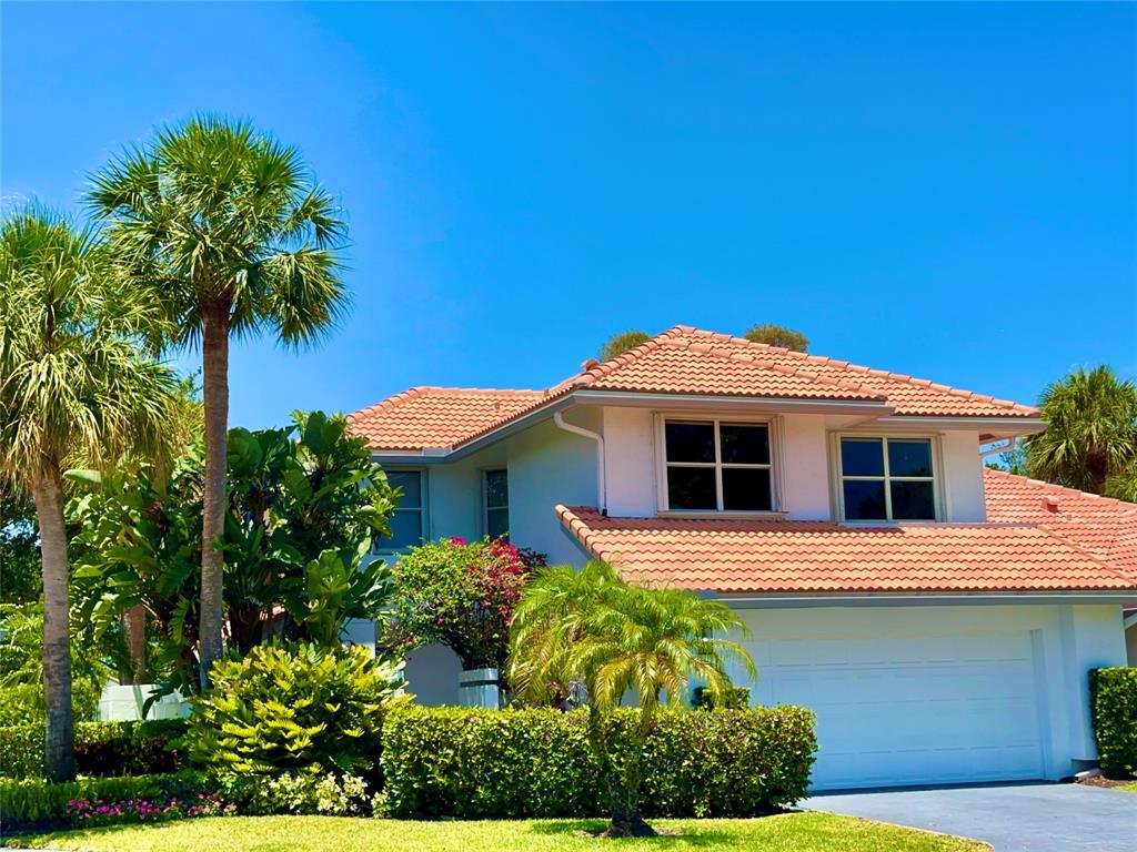 2295 Northwest 53rd Street Boca Raton, FL 33496 - Photo 35 of 89 a front view of a house with a garden