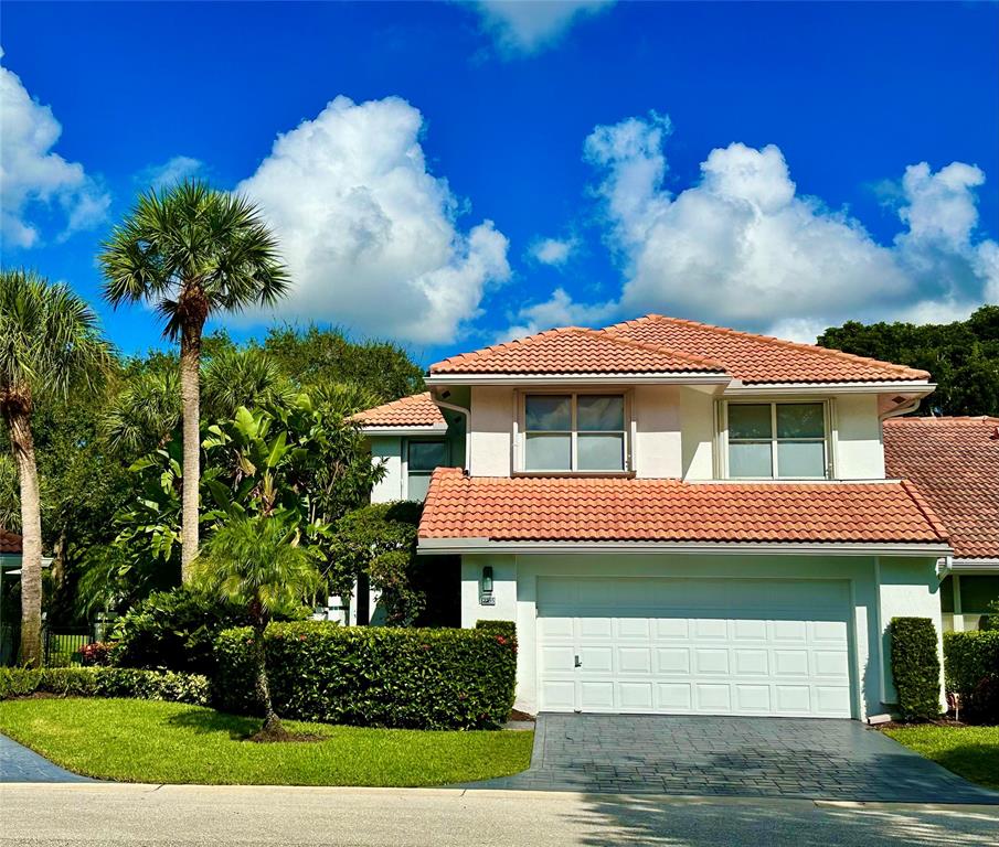 2295 Northwest 53rd Street Boca Raton, FL 33496 - Photo 5 of 89 a front view of a house with a garden