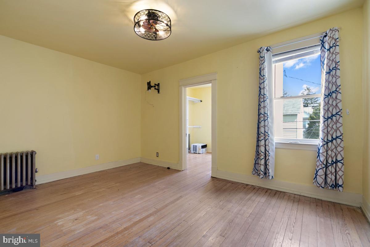 1745 Portship Road Dundalk, MD 21222 - Photo 19 of 44 an empty room with wooden floor and windows