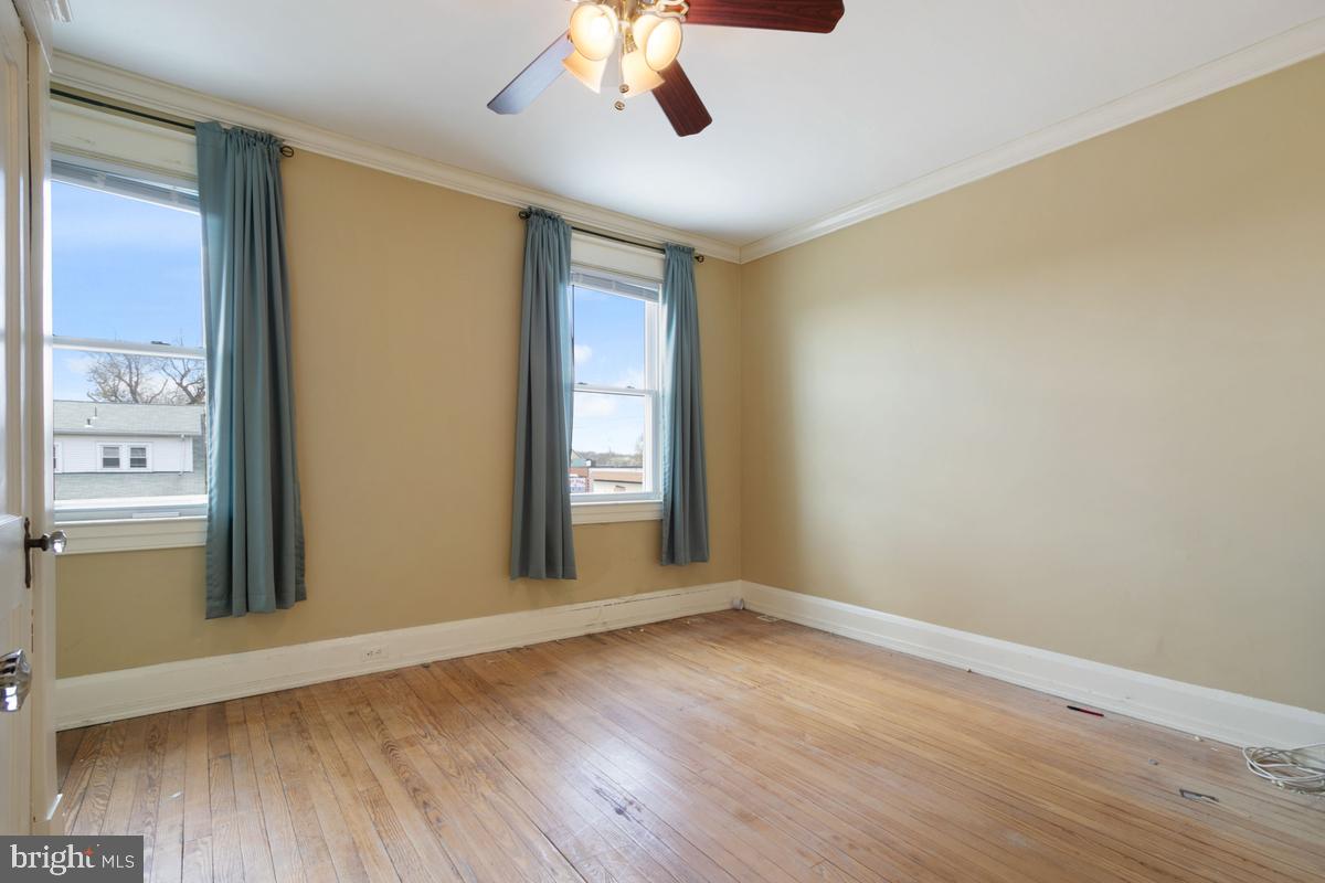 1745 Portship Road Dundalk, MD 21222 - Photo 27 of 44 a view of an empty room with wooden floor and a window
