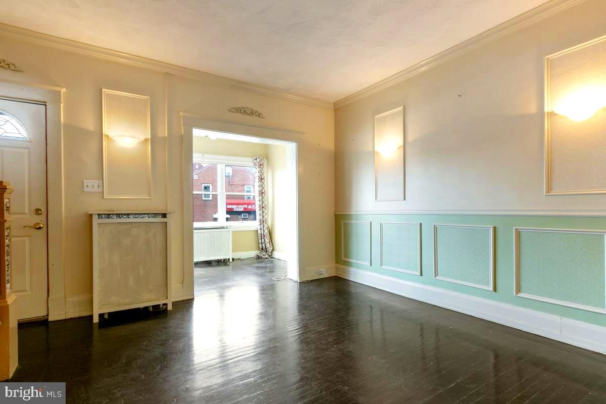 1745 Portship Road Dundalk, MD 21222 - Photo 6 of 44 a view of empty room with wooden floor and fan
