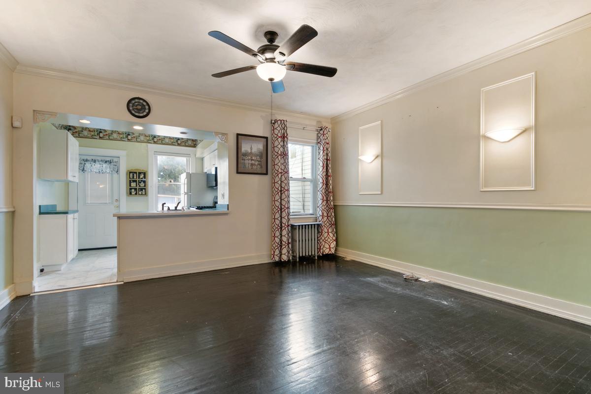 1745 Portship Road Dundalk, MD 21222 - Photo 10 of 44 a view of an empty room with wooden floor and a window