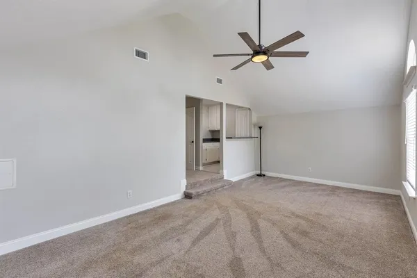 a view of empty room with ceiling fan