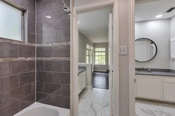a bathroom with a mirror a double vanity sink and a mirror