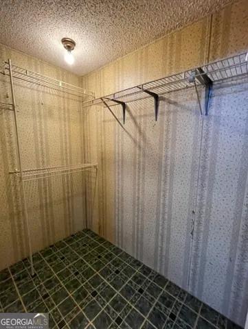 an empty room with windows and painted walls