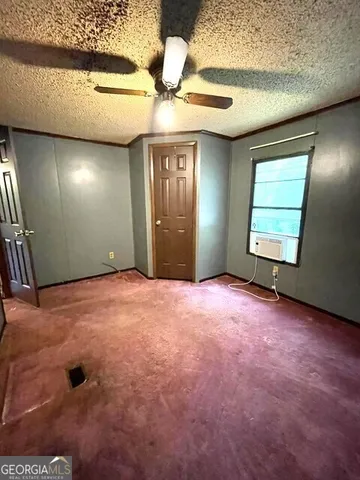 a room with a bed and a dresser