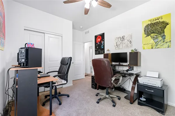 a view of a workspace with furniture and a window