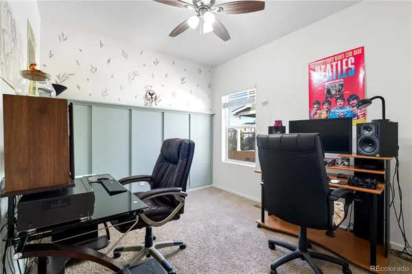 a view of a workspace with furniture and a window