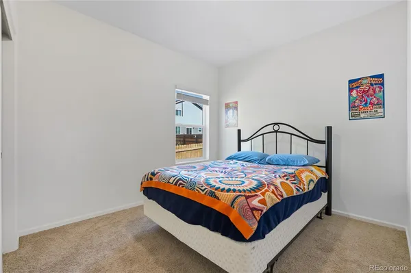 a bedroom with a bed and dresser