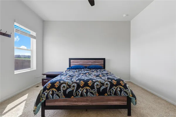 a bedroom with a bed and window