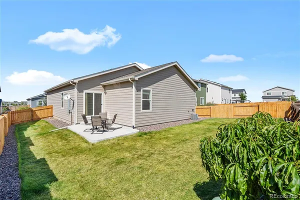a view of a house with backyard and sitting area