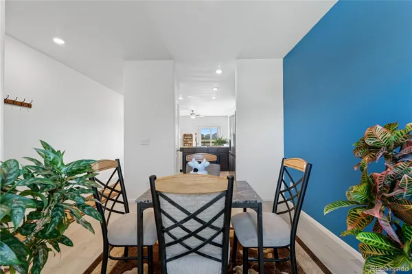 a dining room with furniture and a potted plant