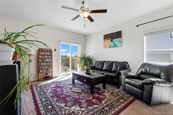 a living room with furniture a rug and a window