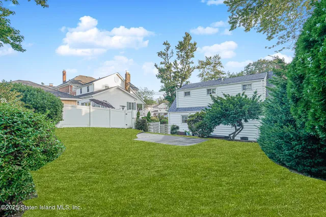 an aerial view of a house with garden space and street view