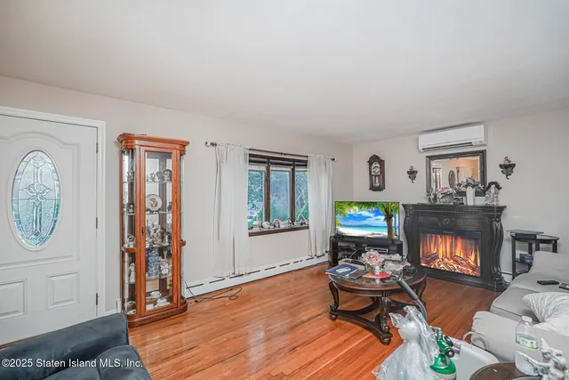 a living room with furniture a window and a fireplace