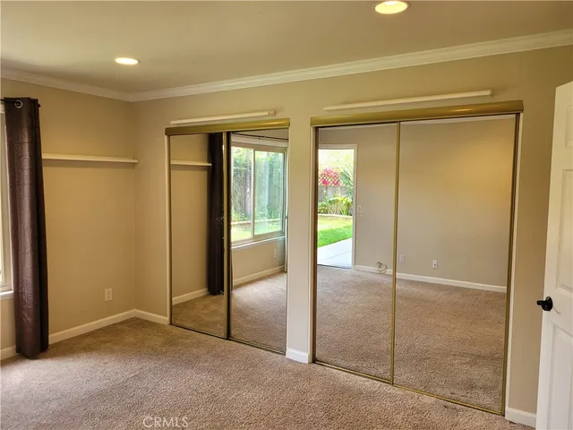 a view of a kitchen with cabinets and wooden floor
