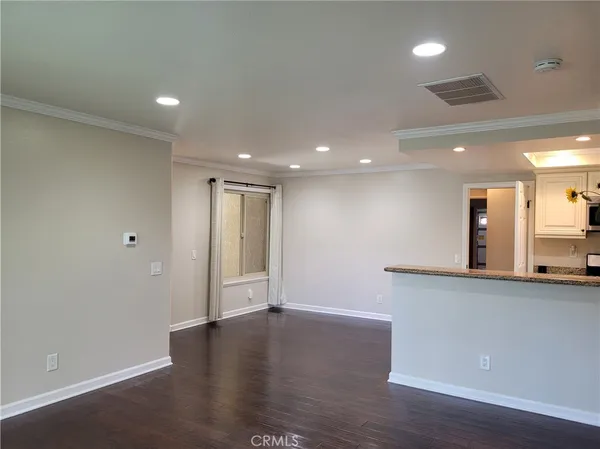 a kitchen with stainless steel appliances granite countertop a sink and a refrigerator