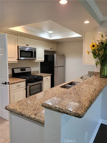 a stove top oven sitting inside of a kitchen