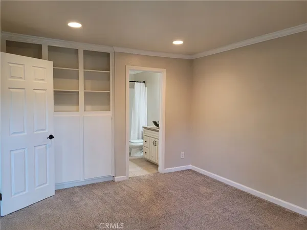a bathroom with a granite countertop bathtub shower sink vanity and toilet