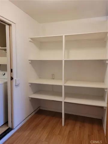 a view of a room with wooden floor