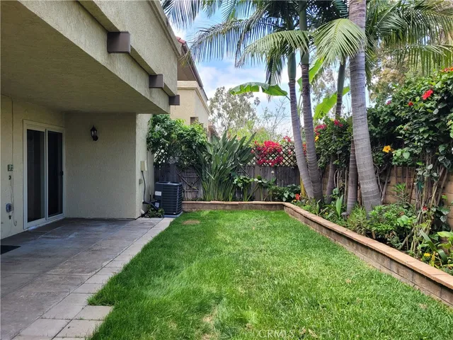 a view of a backyard with table and chairs and a garage