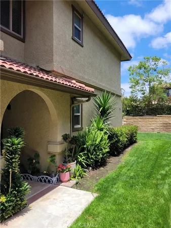 a backyard of a house with a garden and plants