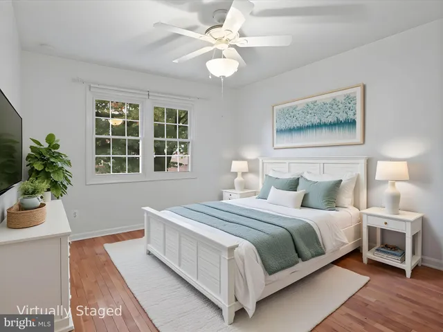 a bedroom with a large bed chandelier and a window