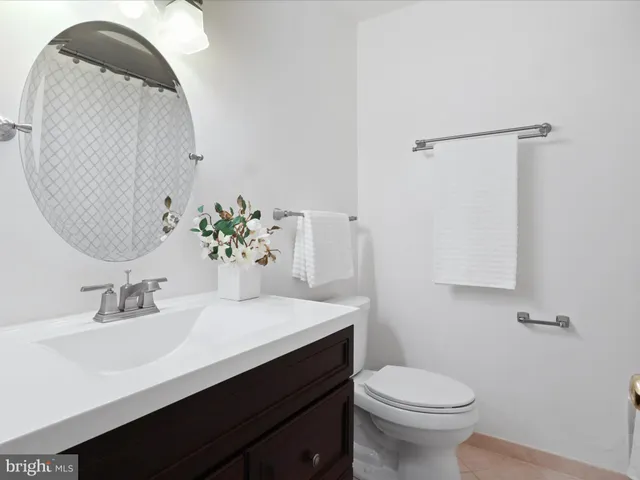 a bathroom with a sink vanity and toilet