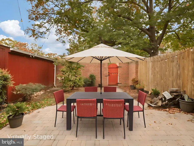 a view of a tables and chairs under an umbrella