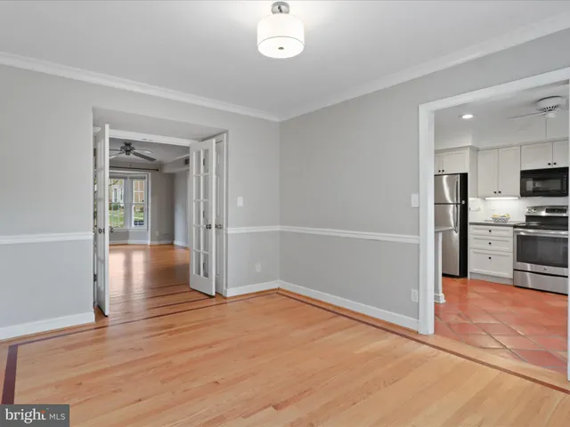 a view of a kitchen with wooden floor and a sink