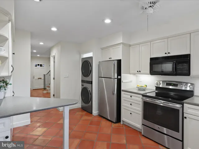 a kitchen with stainless steel appliances a refrigerator stove and microwave