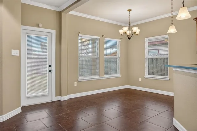 a view of livingroom with window chandelier fan and kitchen view