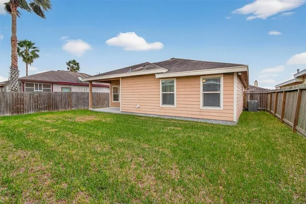 a front view of a house with a garden and yard