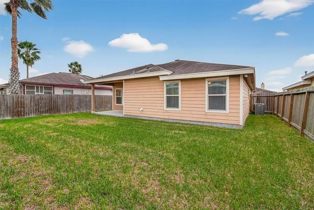 a front view of a house with a garden and yard