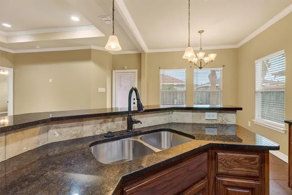 a kitchen with granite countertop a sink and a window