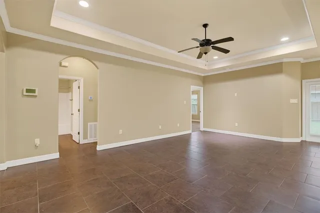 a view of an empty room with a ceiling fan