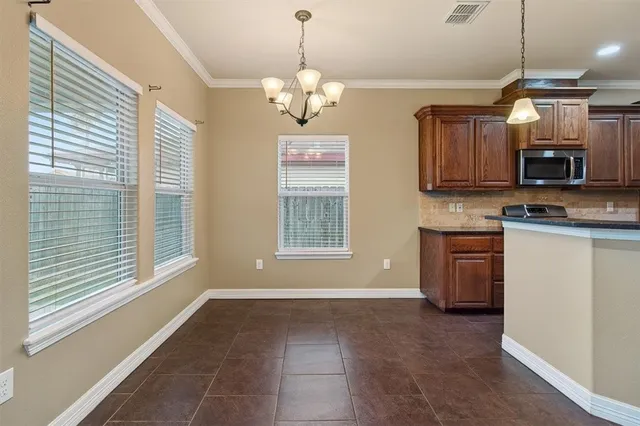 a view of a kitchen with a stove and cabinets