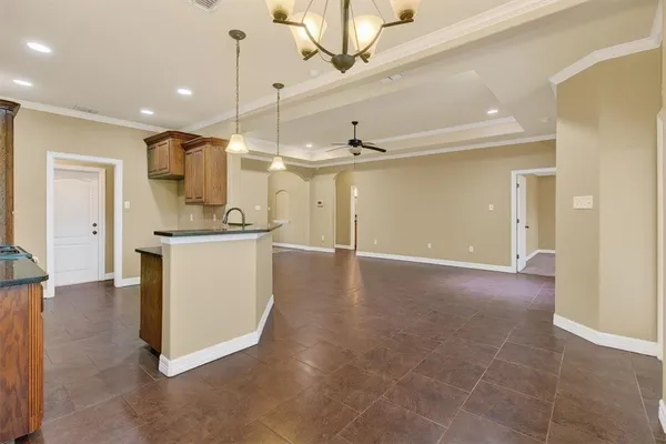a view of a kitchen with a sink and a refrigerator