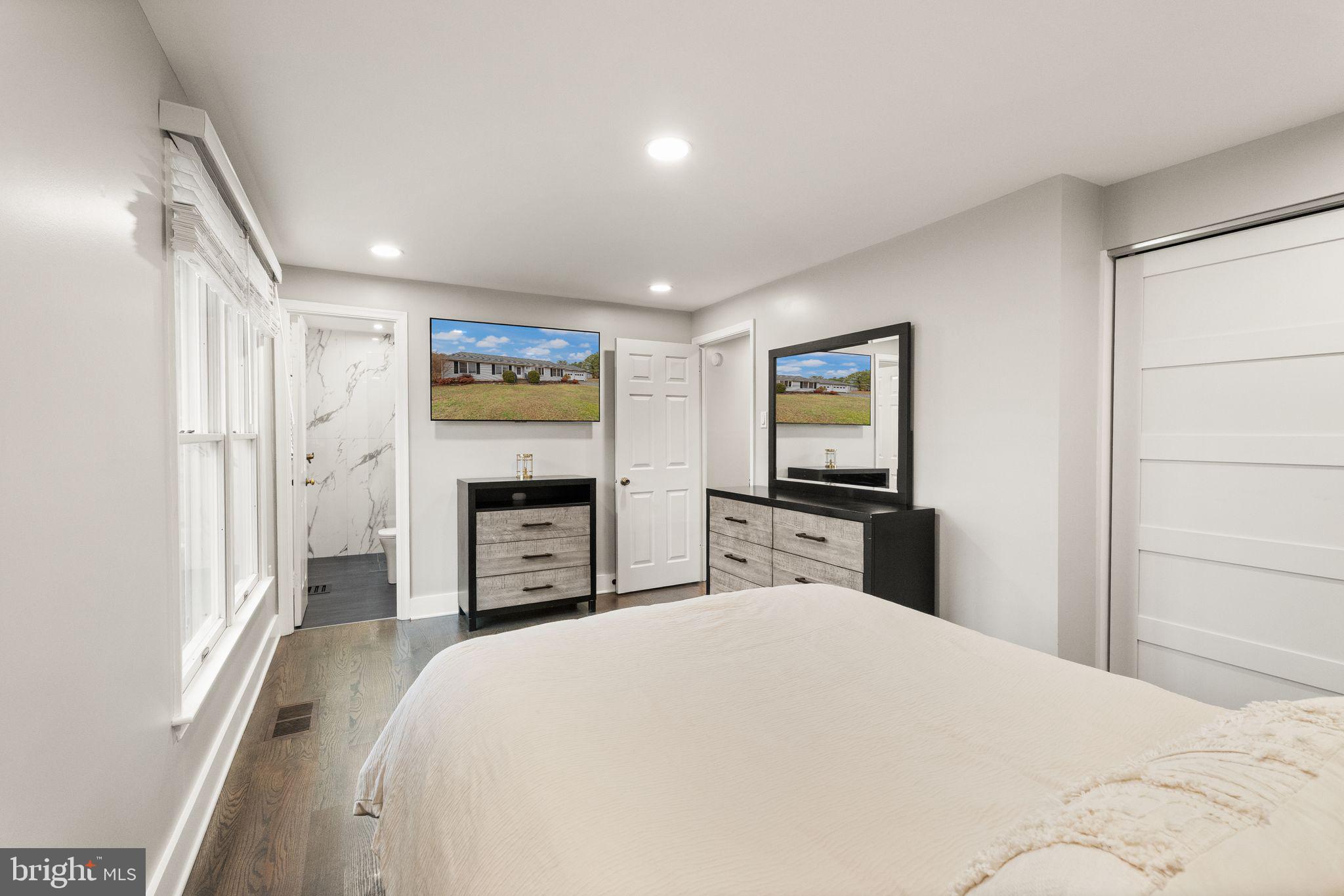 14068 Carriage Ford Road Nokesville, VA 20181 - Photo 24 of 48 a bedroom with a large bed and a tv