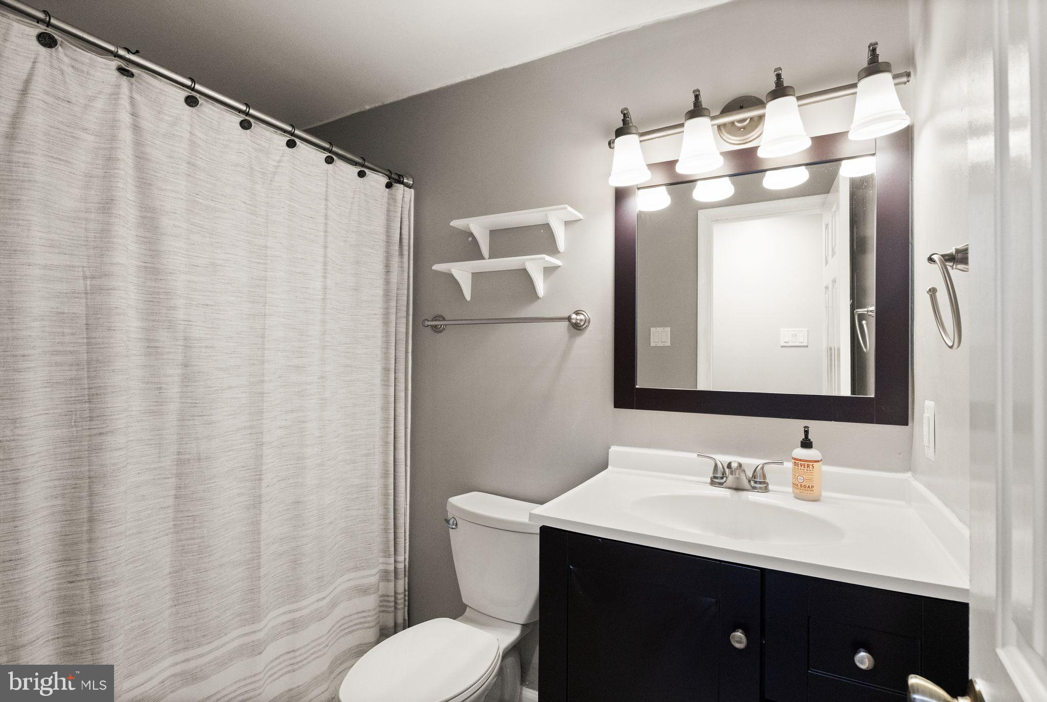 14068 Carriage Ford Road Nokesville, VA 20181 - Photo 32 of 48 a bathroom with a sink vanity mirror and toilet