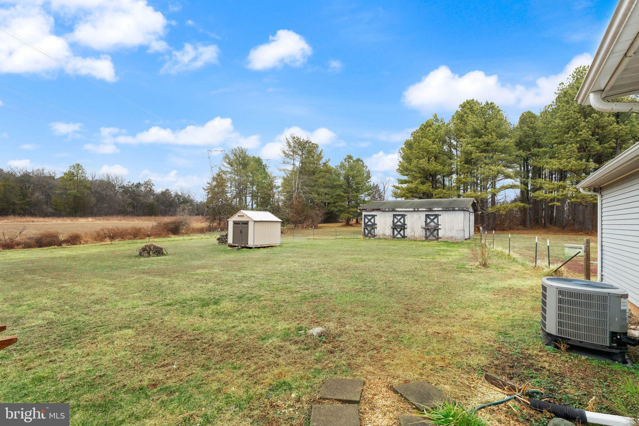 14068 Carriage Ford Road Nokesville, VA 20181 - Photo 35 of 48 a house view with swimming pool and trees in the background