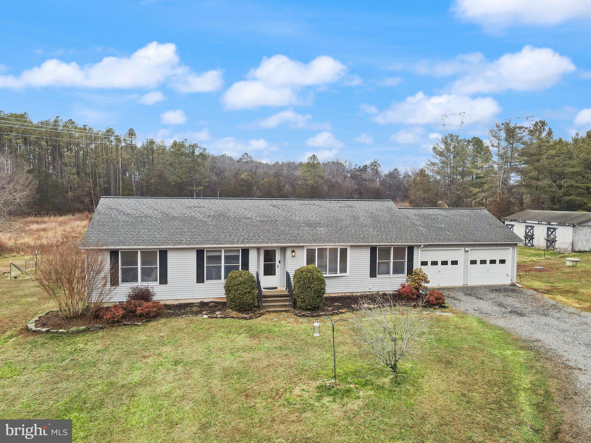 14068 Carriage Ford Road Nokesville, VA 20181 - Photo 4 of 48 an aerial view of a house with swimming pool and a yard